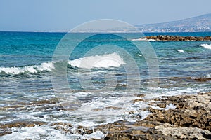 Seascape of the Mediterranean Sea with waves of the turquoise sea on the volcanic coast of Cyprus