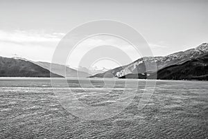 Seascape and mountain landscape on blue sky background in alaska