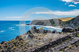 Seascape in the Natural Reserve of Alagoa da FajÃÂ£zinha with path in volcanic stones and up the horizon, Terceira - Azores PORTUGA photo