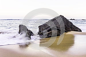 Seascape with the ocean in motion at sunset in sandy Adraga Beach