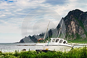 Seascape with old fishing boat on shore