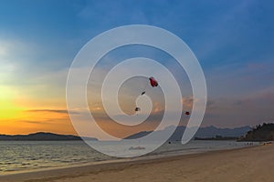 Seascape with parasailing. Sunset on the beach of Langkawi Island, Malaysia