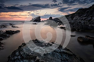 Seascape with picturesque rocks at sunrise