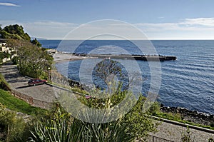 Seascape of pier for fishing boat with coastal road in the Black Sea and small beach near ancient city Nessebar