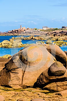 Ploumanac`h lighthouse and granite boulders on the Pink Granite Coast in Brittany, France photo