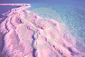 Seascape in pink light, texture of Dead sea. Salty sea shore