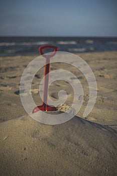 seascape with red plastic sea shovel