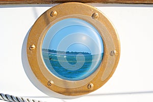Seascape reflection in sailboat porthole