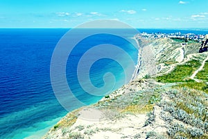 Seascape with rocks, blue sky and Caucasus mountains on the black sea