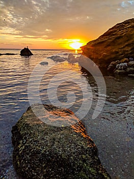 Seascape with rocks and nice sky in the summer season during the sunset