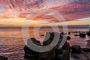 Seascape with rocks and nice sky in the summer season during the sunset