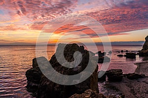 Seascape with rocks and nice sky in the summer season during the sunset