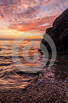 Seascape with rocks and nice sky in the summer season during the sunset