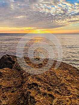 Seascape with rocks and nice sky in the summer season during the sunset