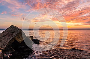 Seascape with rocks and nice sky in the summer season during the sunset