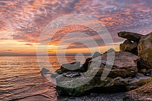 Seascape with rocks and nice sky in the summer season during the sunset