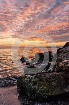 Seascape with rocks and nice sky in the summer season during the sunset