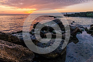 Seascape with rocks and nice sky in the summer season during the sunset