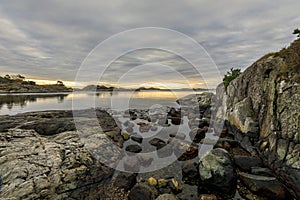 Seascape with rocks, sea and clouds. Grimstad in Norway