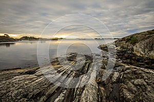 Seascape with rocks, sea and clouds. Grimstad in Norway