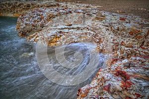 Seascape - Rocks with washing waves at Nightcliff, Northern Territory, Australia