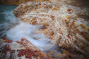 Seascape - Rocks with washing waves at Nightcliff, Northern Territory, Australia