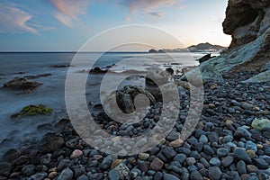 Seascape with a rocky coastline in Cala Higuera, Natural Park of Cabo de Gata, Spain at twilight photo