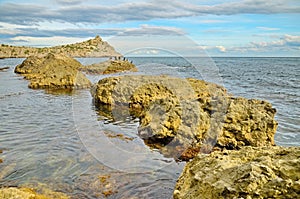 Seascape with row of wild rocks in water sea