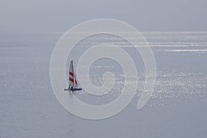 Seascape with a sailboat during Calima on the Canary Islands photo