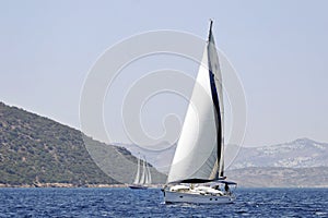 Seascape with sailboat and gulet