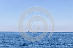 Seascape with sea horizon and almost clear deep blue sky