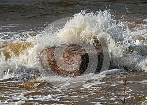 Seascape, sea wave hits stones and explodes, waves and splashes on the shore, Vidzeme`s rocky seashore, Salacgriva rural area,