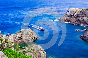 Seascape and ship in Cap de Creus, cape in Cadaques, Girona, Costa Brava, Catalonia, Spain. Mediterranean sea coast of Spain.