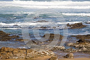 Seascape showing rocks emerging at low tide