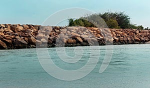 A seascape of the shrine velankanni beach with stone fence.