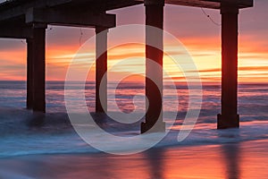 Seascape Silhouette Pier Pilings in Ocean at Sunrise