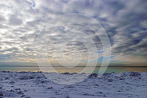 seascape, slow freezing sea, glorious skies, white pieces of ice by the sea