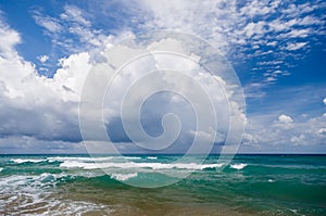 Seascape  small waves with white foam on the background of blue water