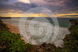 Seascape. Spectacular view from Balangan cliff in Bali. Sunset time. Blue hour. Ocean with motion foam waves. Waterscape for