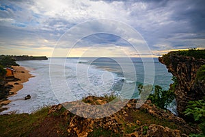 Seascape. Spectacular view from Balangan cliff in Bali. Sunset time. Blue hour. Ocean with motion foam waves. Waterscape for