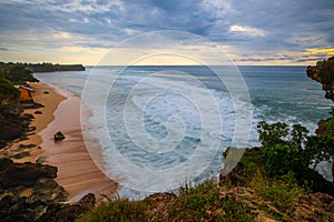 Seascape. Spectacular view from Balangan cliff in Bali. Sunset time. Blue hour. Ocean with motion foam waves. Waterscape for