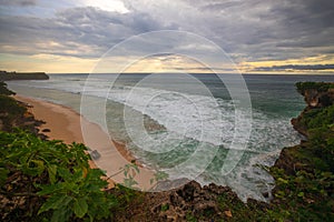 Seascape. Spectacular view from Balangan cliff in Bali. Sunset time. Blue hour. Ocean with motion foam waves. Waterscape for