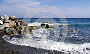 Seascape with stones near Perissa. Santorini island, Greece.