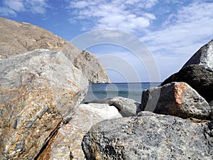 Seascape with stones near Perissa. Santorini island, Greece.