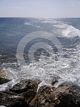 Seascape with stones near Perissa. Santorini island, Greece.