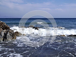 Seascape with stones near Perissa. Santorini island, Greece.