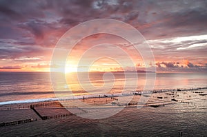 Seascape during the sunrise. Sky and reflections on the water in the summer. Sun rays during the sunrise. Nusa Penida, Bali, Indon