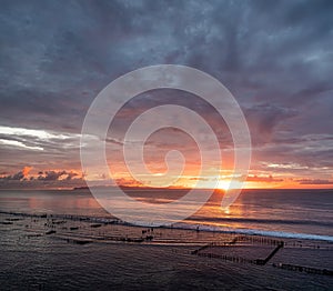 Seascape during the sunrise. Sky and reflections on the water in the summer. Sun rays during the sunrise. Nusa Penida, Bali, Indon