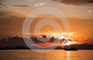 Seascape in sunrise time with fishing boat