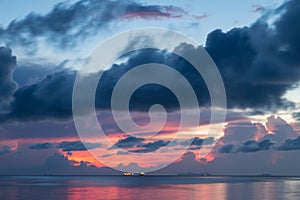 Dramatic seascape sunset with big rain cloud background